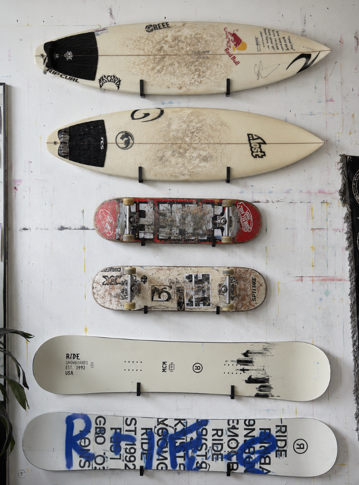 surfboards, skateboards and snowboards on the studio wall
